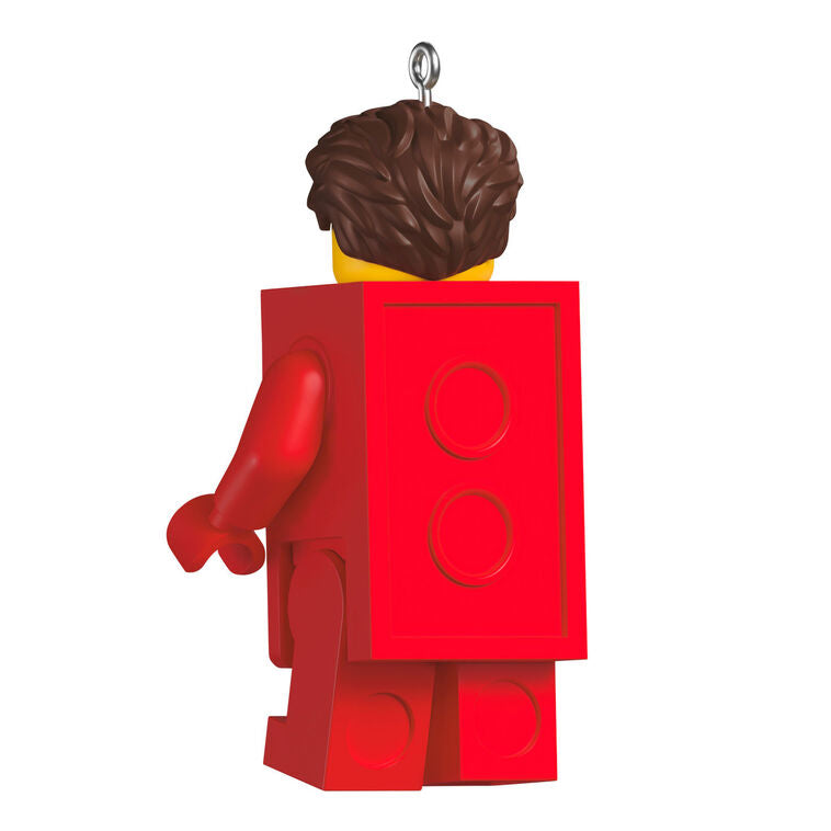 LEGO minifigure ornament with red brick body and blue hand-held piece, smiling boy with brown hair.