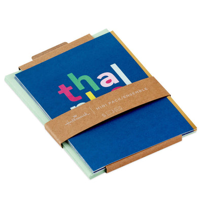 Multicolor “thanks” lettering on blue background thank-you cards with gold foil accents.
