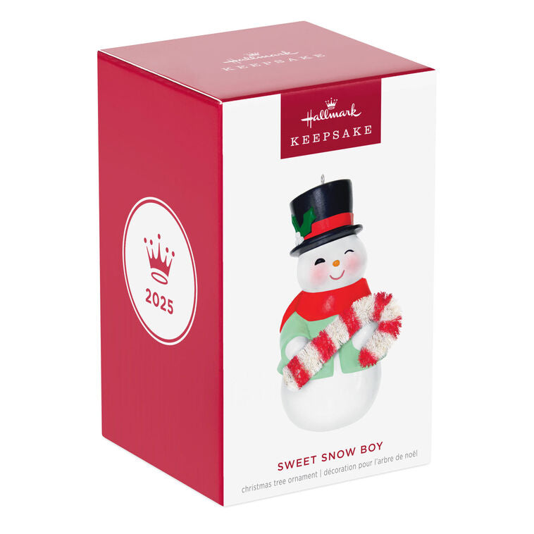 Porcelain snowman ornament in festive coat, scarf, and top hat holding a bottlebrush candy cane