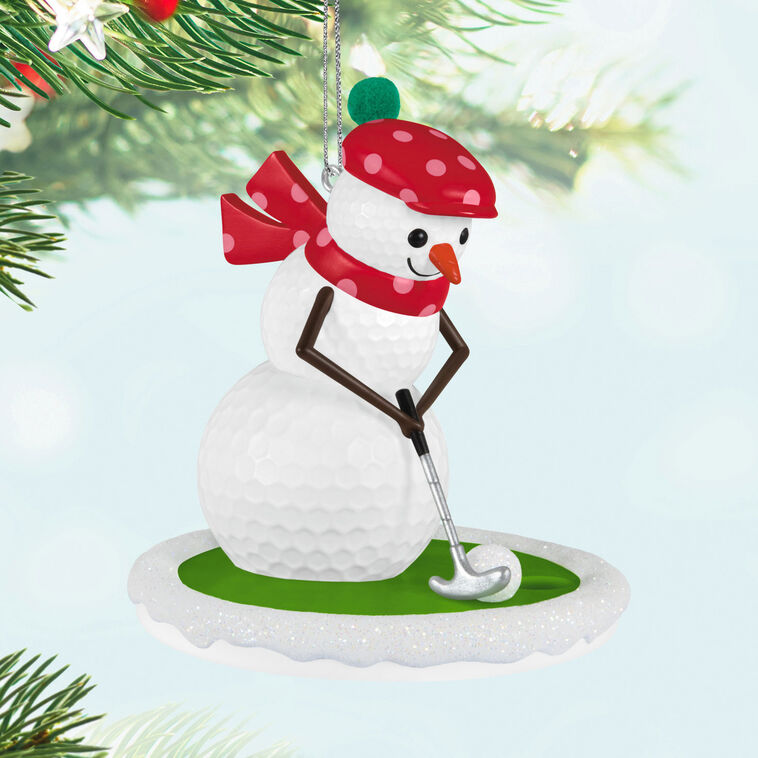 Golf ball snowman ornament in red polka dot hat and scarf, hitting a snowball with a silver putter


