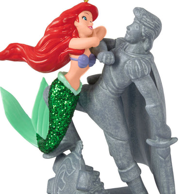 Ariel Christmas ornament gazing at Prince Eric's stone statue, tail curled behind her, from Disney's The Little Mermaid