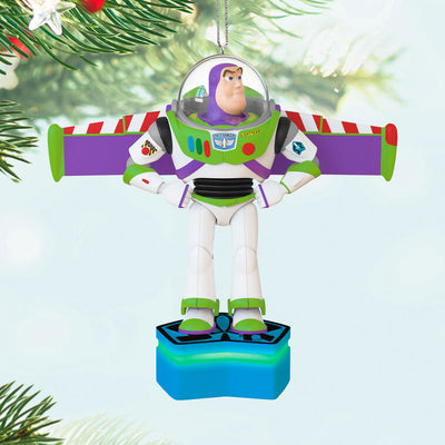 Buzz Lightyear Christmas ornament with wings extended on blue base, featuring light and sound effects
