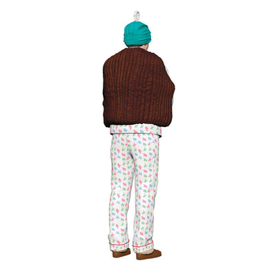 Hallmark Keepsake ornament of Clark Griswold in pajamas, fur stole, gloves, and turban holding a projector from National Lampoon's Christmas Vacation.