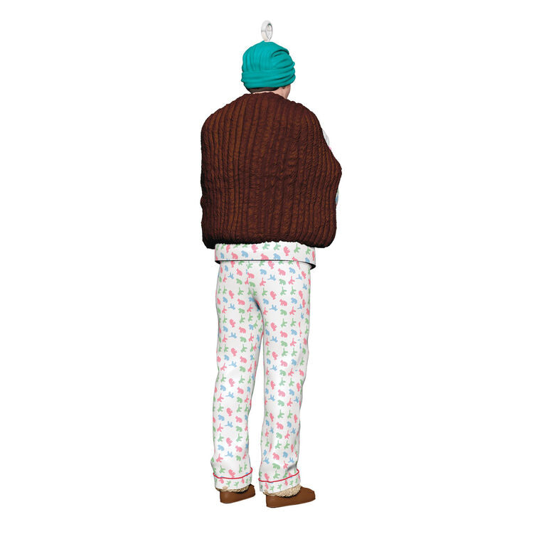 Hallmark Keepsake ornament of Clark Griswold in pajamas, fur stole, gloves, and turban holding a projector from National Lampoon&