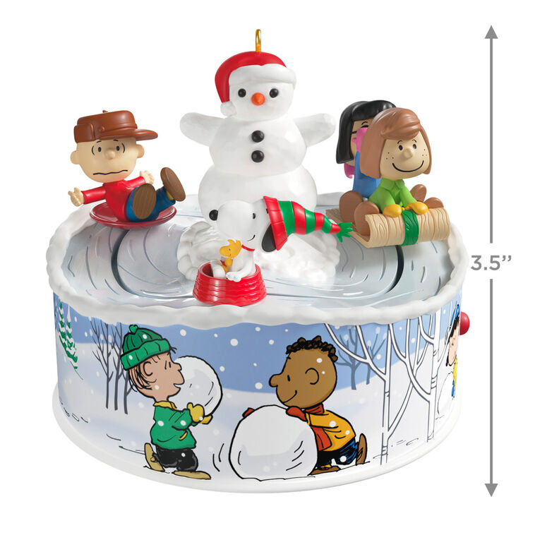 Peanuts Gang sledding ornament with Snoopy, Lucy, and snowman, light-up musical Christmas scene, Hallmark Keepsake motion collectible
