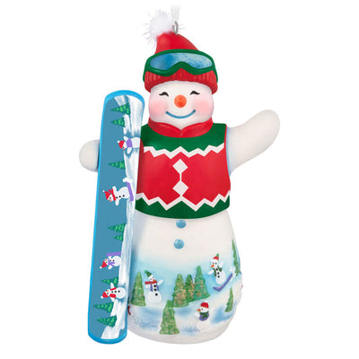 Hallmark Keepsake Ollie U. Halfpipe porcelain snowman ornament in red sweater vest, goggles, stocking hat, holding snowboard, snowy mountain scene