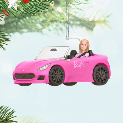 Barbie ornament driving a pink convertible sports car, wearing pink tee and barrettes, Hallmark Keepsake holiday decoration.