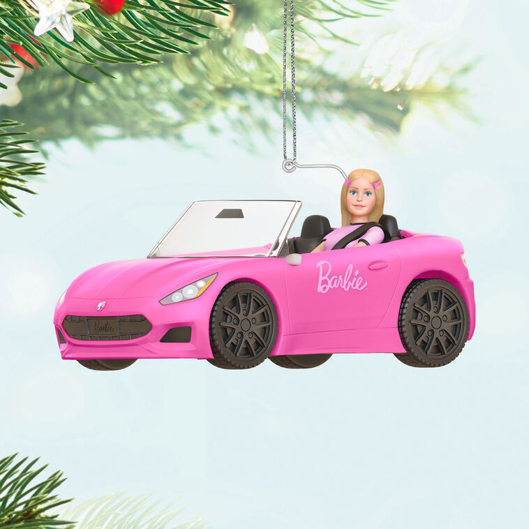 Barbie ornament driving a pink convertible sports car, wearing pink tee and barrettes, Hallmark Keepsake holiday decoration.