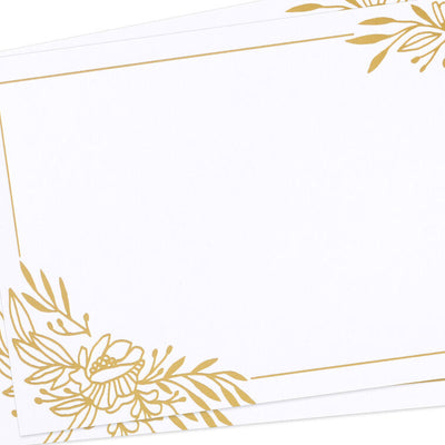 White flat note cards with gold foil corner floral swags and kraft band packaging.
