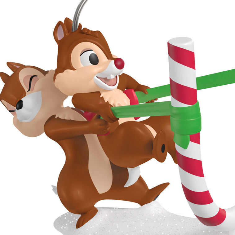 Chip launches Dale from a candy cane catapult in this playful Hallmark Keepsake Disney Christmas ornament with snowy base.