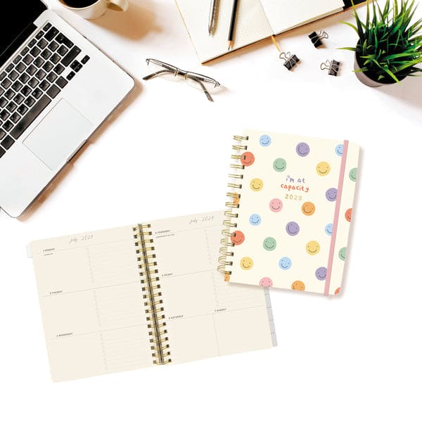 Graphique 6 x 8 hardbound spiral planner with playful cover, elastic band, laminated tabs, and gold foil stickers.

