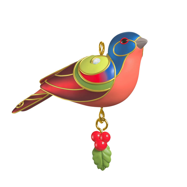 Painted Bunting miniature Christmas tree ornament with colorful feathers, metallic gold trim, and dangling holly berry charm