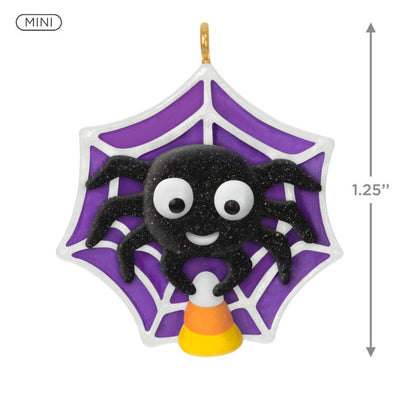 Mini Halloween spider ornament holding candy corn in sparkly web, perfect for tabletop tree display