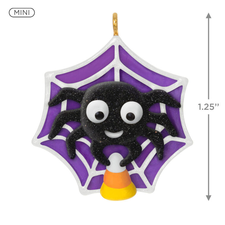 Mini Halloween spider ornament holding candy corn in sparkly web, perfect for tabletop tree display