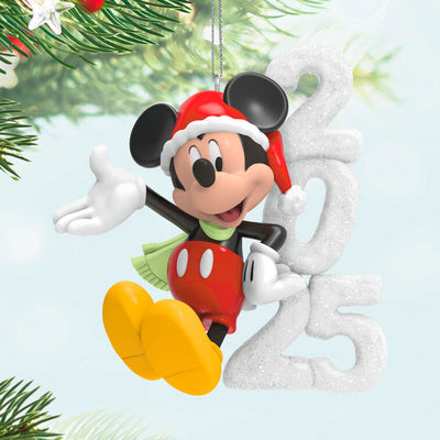 Mickey Mouse in Santa hat and scarf smiles next to a glittery “2025” snow sculpture in this festive Hallmark Keepsake Disney ornament.