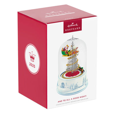 Santa sleigh and toy train under glass dome with lights and motion on snowy village base