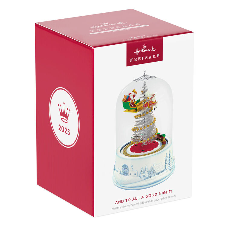 Santa sleigh and toy train under glass dome with lights and motion on snowy village base