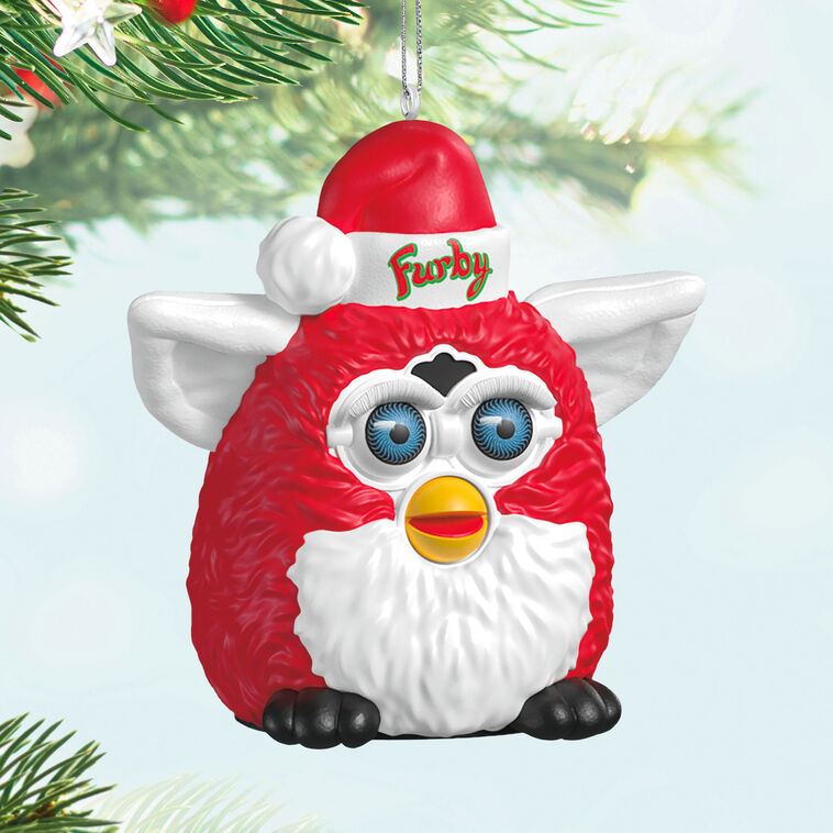 Festive Furby ornament, red and white electronic toy with blue eyes, yellow beak, Santa hat, Hallmark Keepsake, Christmas decoration.