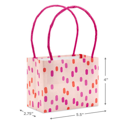 Assorted mini horizontal gift bags with pink stripes, polka dots, squiggles, and multicolor daisies, pink handles, Hallmark
