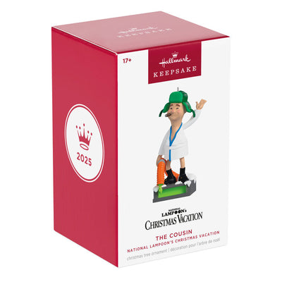 Cousin Eddie ornament from Hallmark Keepsake, wearing a bathrobe and trapper hat, standing next to an RV toilet from National Lampoon's Christmas Vacation.