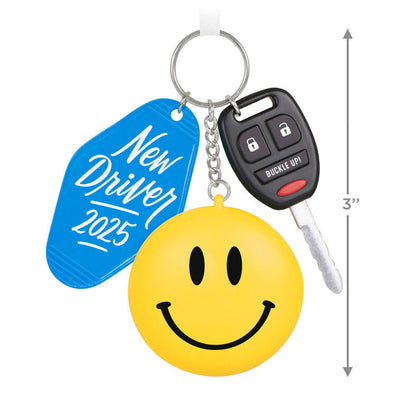 Keychain ornament with car key, smiley face, and blue “New Driver 2025” tag, featuring a small photo frame on back.