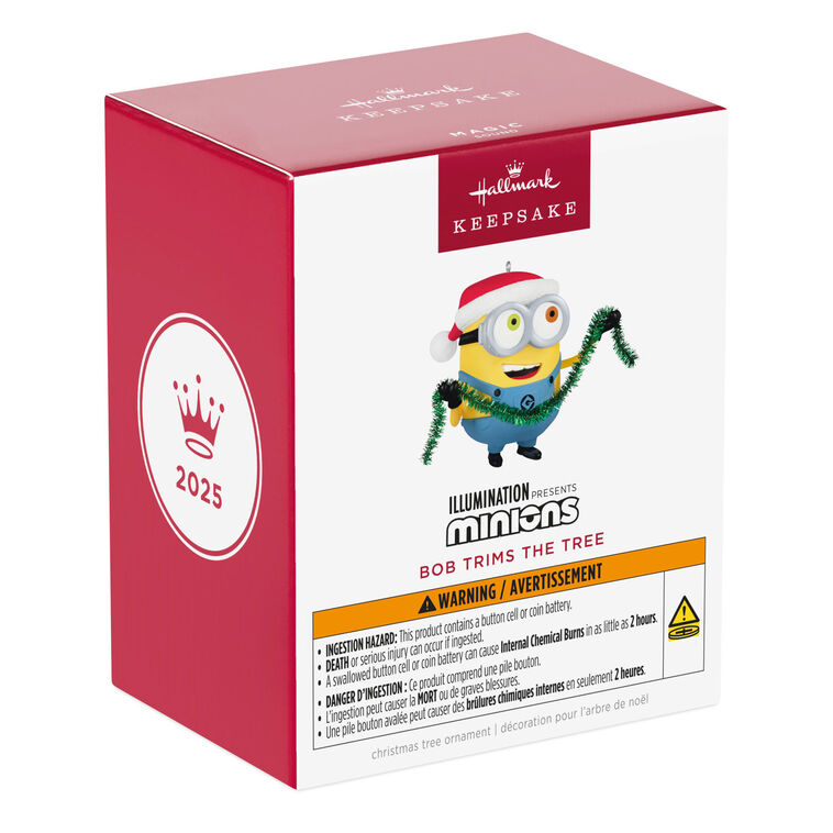Minion Bob ornament in Santa hat holding green tinsel garland with a big smile