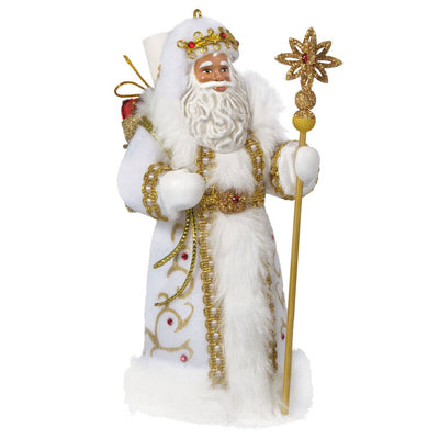 Black Father Christmas ornament in white coat with gold staff, faux-fur trim, and red gem accents.

