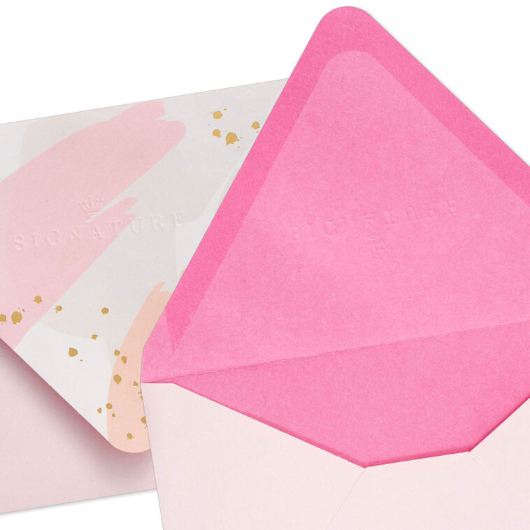 Pink envelopes with white and pink brushstroke flap design and scattered gold foil dot accents, featuring pointed flaps.
