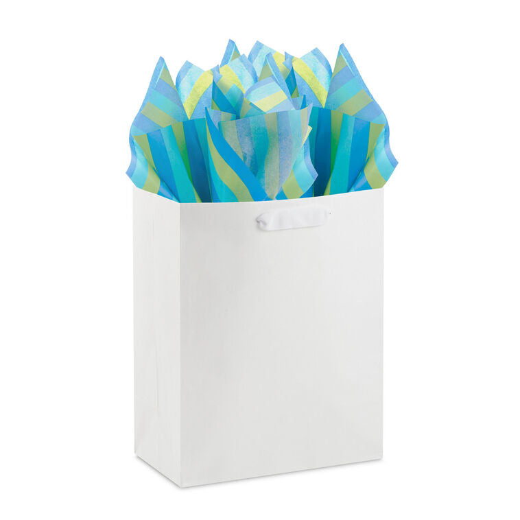 Hallmark tissue paper in bold horizontal stripes of royal blue, aqua, and green, shown both flat and fluffed in a white gift bag.