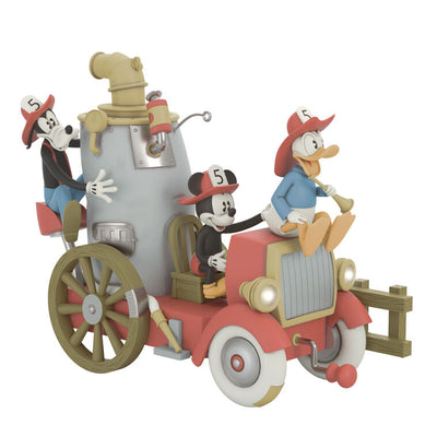 Mickey, Donald, and Goofy on a vintage fire engine ornament with light, sound, and motion from Mickey’s Fire Brigade.

