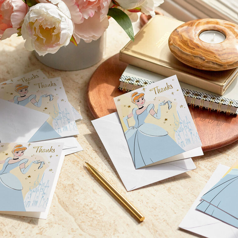 Thank-you cards featuring Disney’s Cinderella in her ball gown with a glass slipper, gold foil stars, and castle sketch.
