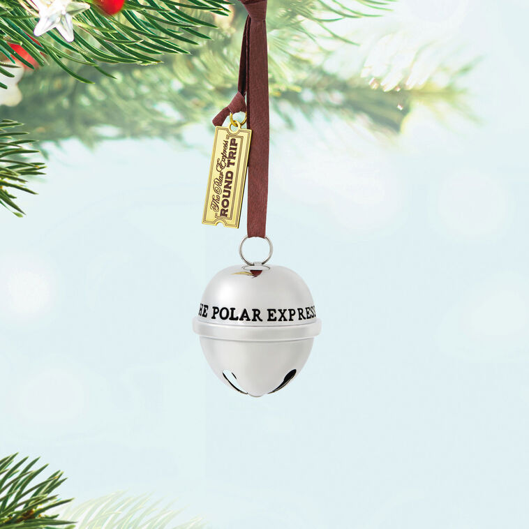 Shiny metal sleigh bell Christmas ornament from The Polar Express with gold ticket tag, faux leather hanger, and commemorative 2025 date.