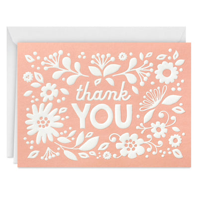 Coral thank-you cards with white embossed floral designs, shown with matching envelopes and presented in a gray gift box.

