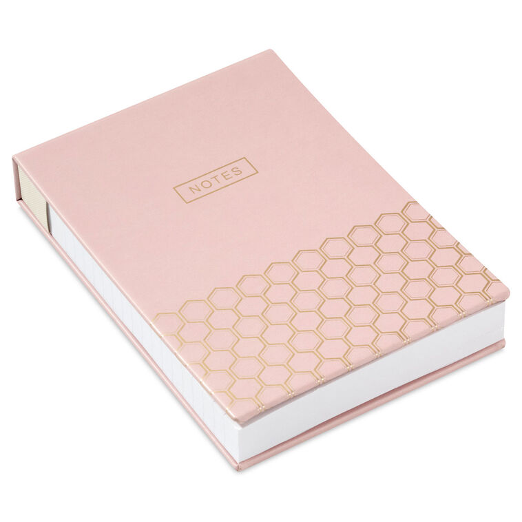 Pastel pink faux leather list pad with gold foil honeycomb design and lined, perforated pages.
