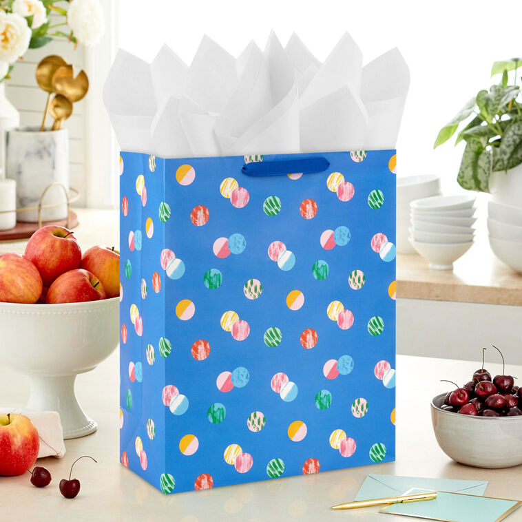 Hallmark extra-large gift bag with playful polka dots on a blue background, ideal for birthdays, holidays, or celebrations.