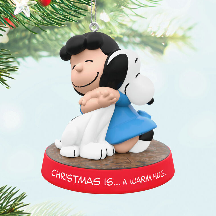 Hallmark Keepsake ornament of Lucy hugging Snoopy, Peanuts Gang Christmas Is series, red base with heartfelt sentiment