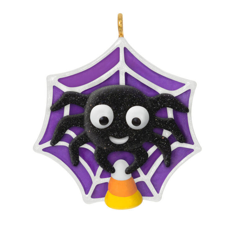 Mini Halloween spider ornament holding candy corn in sparkly web, perfect for tabletop tree display
