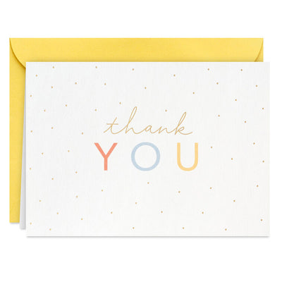 White thank-you cards with pastel-colored lettering and scattered gold foil dots, packaged in a kraft box with matching envelopes.
