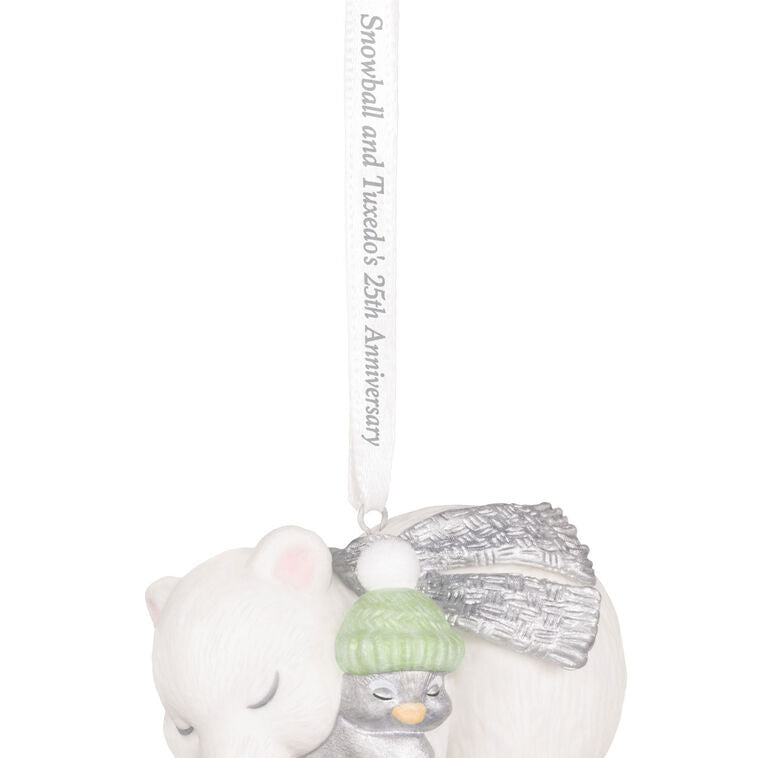 Hallmark Keepsake ornament of Snowball the polar bear cuddling Tuxedo the penguin, white and silver design celebrating 25th anniversary.