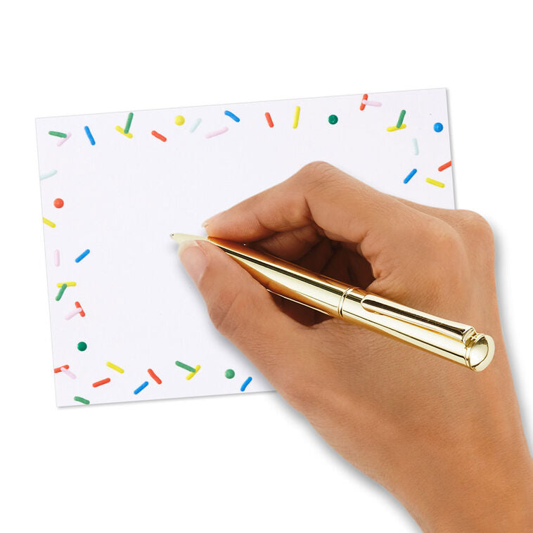 White flat note cards with colorful confetti sprinkle border design, bundled in kraft paper wrap.
