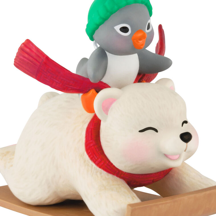 Tuxedo penguin in green hat rides Snowball the polar bear on toboggan, Hallmark Keepsake Christmas ornament