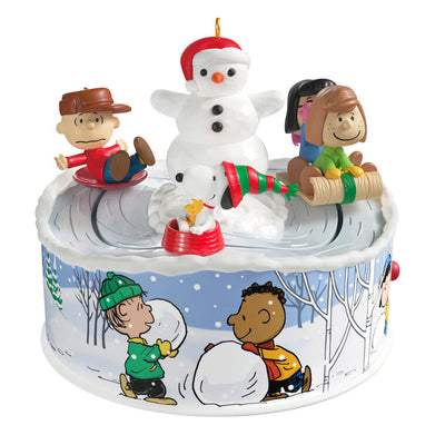 Peanuts Gang sledding ornament with Snoopy, Lucy, and snowman, light-up musical Christmas scene, Hallmark Keepsake motion collectible
