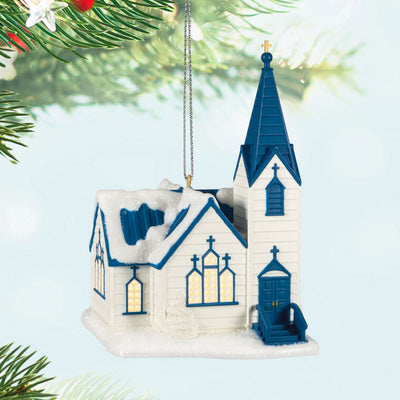 White church ornament with blue roof, steeple, and glowing windows, designed to light up with miniature Christmas light string.