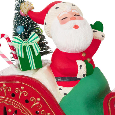 Vintage-style Santa in red sleigh with gifts and lighted base, part of ShowToppers musical tree topper system with synchronized effects.