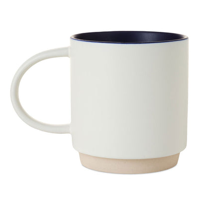 White ceramic mug with colorful "Every day is a Dadventure" lettering, oversized handle, and recessed base for stacking