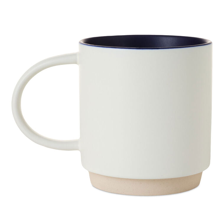 White ceramic mug with colorful "Every day is a Dadventure" lettering, oversized handle, and recessed base for stacking