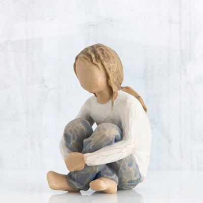 Willow Tree Spirited Child figurine of seated girl with arms wrapped around knees.