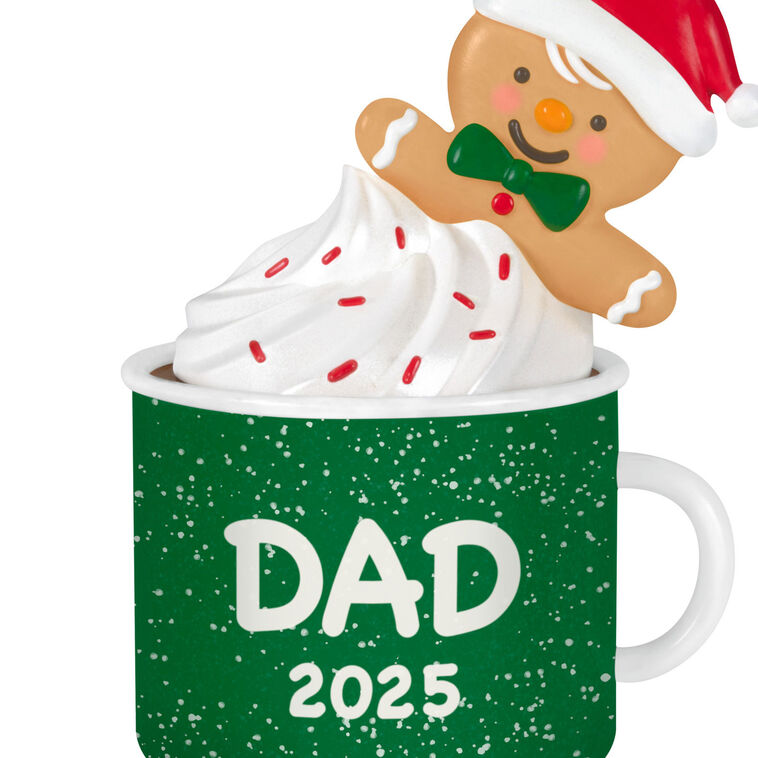 2025 Christmas ornament of gingerbread dad cookie in green mug with whipped cream, festive holiday design

