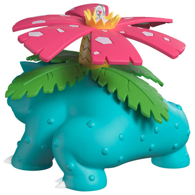 Hallmark Keepsake Pokémon Venusaur ornament with pink blossom on its back, blue-green body, red eyes, and festive Christmas style.