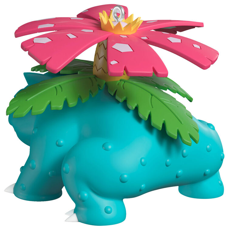 Hallmark Keepsake Pokémon Venusaur ornament with pink blossom on its back, blue-green body, red eyes, and festive Christmas style.